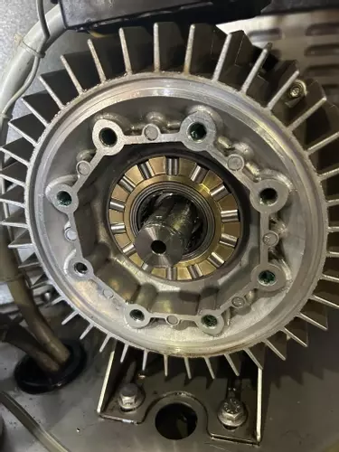 Close-up of brand new rear roller bearing track installed during service on a Nilfisk SH Truck Booster, showing clean and unworn components ready for operation.